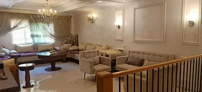 a living room with a couch and a table at Duplex Rahma in Fès