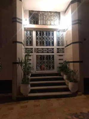 a front door of a building with potted plants at Duplex Rahma in Fès