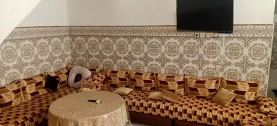 a living room with a couch and a table at Duplex Rahma in Fès