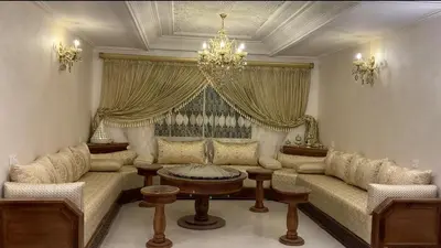 a living room with a couch and a table at Duplex Rahma in Fès
