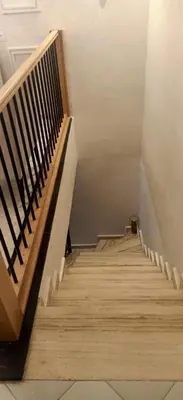 a stairway with wooden stairs and a wooden railing at Duplex Rahma in Fès