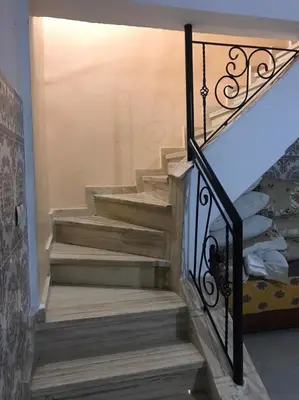 a set of stairs with a wrought iron railing at Duplex Rahma in Fès