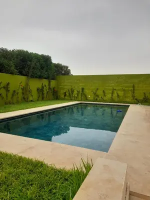 a swimming pool in the middle of a yard at Villa à louer in Oulad Akkou