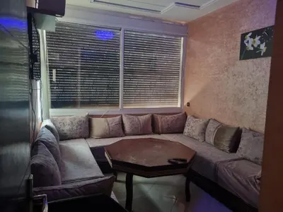 a living room with a couch and a table at Vip charme in Fès