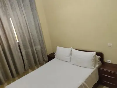 a bed with white pillows in a room with a window at Dar Yasmine in Ifrane