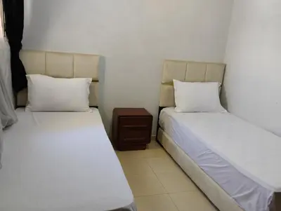 two beds sitting next to each other in a room at Dar Yasmine in Ifrane