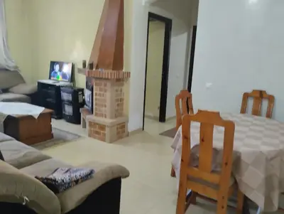 a living room with a couch and a fireplace at Dar Yasmine in Ifrane