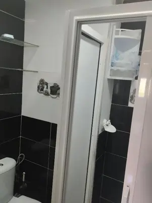 a bathroom with a shower with a toilet and a mirror at Dar Yasmine in Ifrane