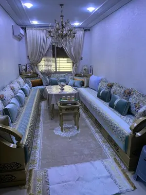 a living room with a large couch and a table at Jnane meknes 2 in Meknès