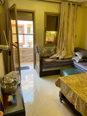a living room with a couch and a window at Jnane meknes 2 in Meknès