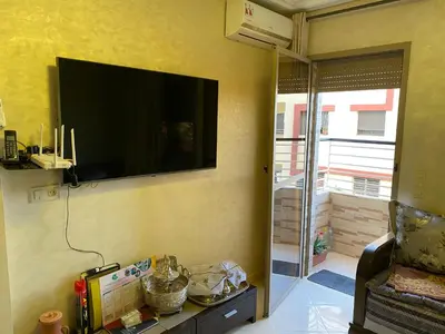 a living room with a flat screen tv on the wall at Jnane meknes 2 in Meknès