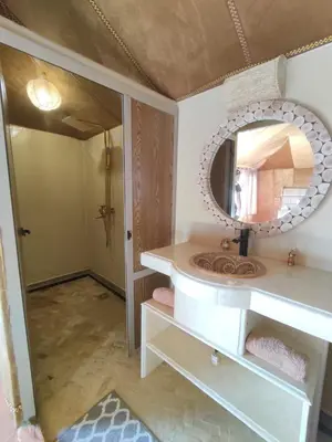 a bathroom with a sink and a mirror at ChariF Luxury Camp in Rissani