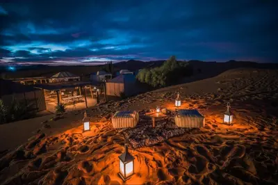 a group of tents in the desert at night at Luxury sahara in Merzouga