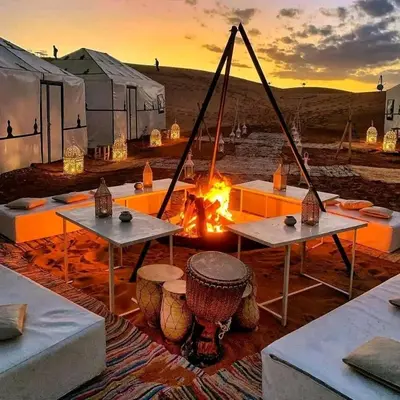 a camp with a fire in the desert at Luxury sahara in Merzouga