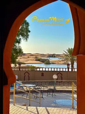 a view of a patio with tables and chairs at caravanmaroc in Er Rachidia
