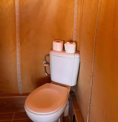 a bathroom with a toilet with two rolls of toilet paper at TRIP Merzouga luxury camp in Hassilabied