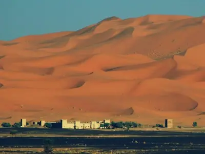 a sand dune in the middle of a desert at TRIP Merzouga luxury camp in Hassilabied