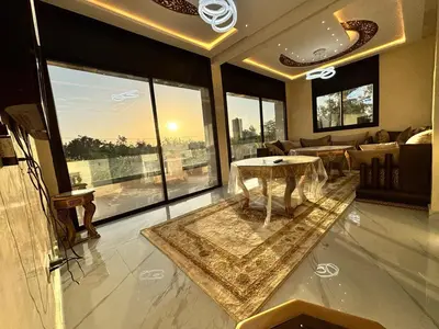 a living room with a couch and a table at Villa Atlas in Aghmat