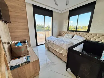 a bedroom with a bed and a large window at Villa Atlas in Aghmat