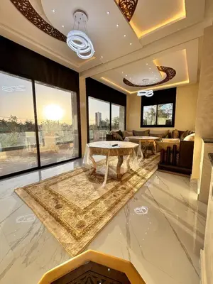 a living room with a table and large windows at Villa Atlas in Aghmat