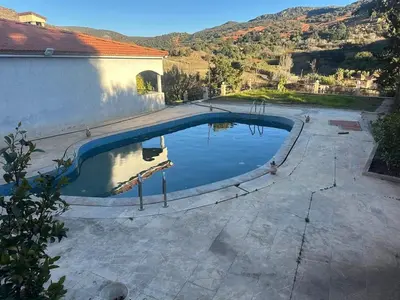 a swimming pool in the middle of a yard at Ferme avec piscine et vue panoramique in Khenifra