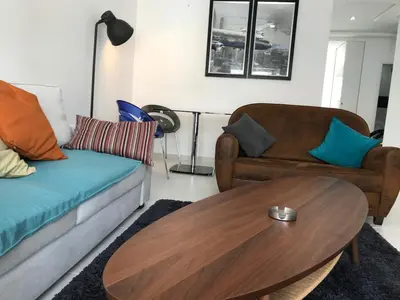 a living room with a couch and a table at American Style Apt Pool & AC in Oulad Akkou