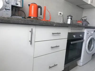 a kitchen with a washer and a washing machine at American Style Apt Pool & AC in Oulad Akkou