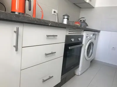 a kitchen with a washer and a washing machine at American Style Apt Pool & AC in Oulad Akkou