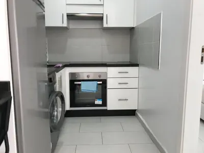 a kitchen with a washer and a microwave in it at Spacious Apartment PoolAir Conditioning Terrace in Oulad Akkou