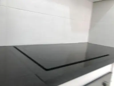 a glass table in a room with a white wall at Spacious Apartment PoolAir Conditioning Terrace in Oulad Akkou
