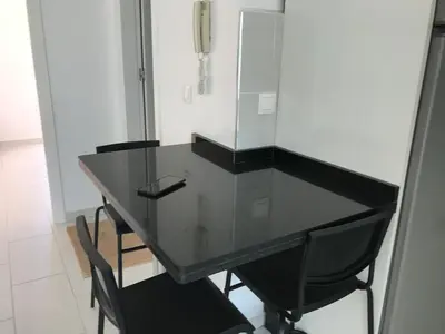 a black table with black chairs in a room at Spacious Apartment PoolAir Conditioning Terrace in Oulad Akkou