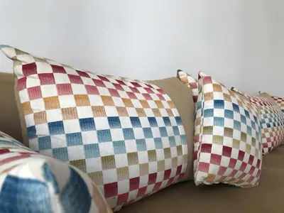 a group of pillows sitting on top of a couch at Cozy Apartment Near the Beach & Public Pool in Oulad Akkou