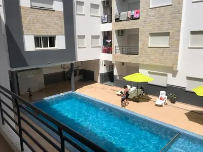 an overhead view of a swimming pool in a building at Cozy Apartment Near the Beach & Public Pool in Oulad Akkou