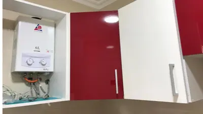 a red door in a kitchen with a red cabinet at Relaxing Stay in Martil CalmView in Oulad Akkou