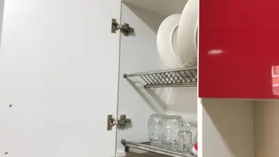 a kitchen with plates and glasses on a shelf at Relaxing Stay in Martil CalmView in Oulad Akkou