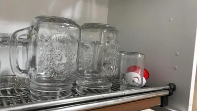a group of glass jars sitting on a shelf at Relaxing Stay in Martil CalmView in Oulad Akkou