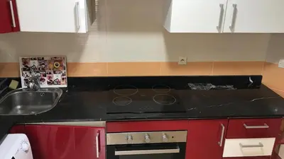 a kitchen with a black counter top and a sink at Relaxing Stay in Martil CalmView in Oulad Akkou