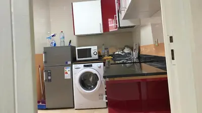 a kitchen with a washing machine and a microwave at Relaxing Stay in Martil CalmView in Oulad Akkou