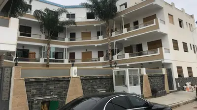 a black car parked in front of a building at Relaxing Stay in Martil CalmView in Oulad Akkou