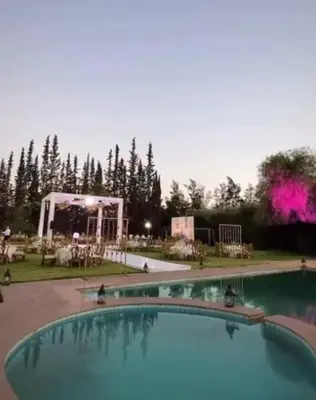 a large swimming pool with a stage in the background at Exceptional villa in Marrakech - privacy and comfort in Heddad