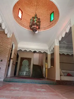 a lobby with a chandelier and stairs in a building at Exceptional villa in Marrakech - privacy and comfort in Heddad