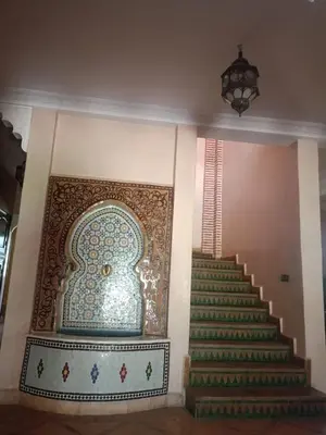 a stairway with a mural on the wall and a stair case at Exceptional villa in Marrakech - privacy and comfort in Heddad