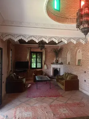 a living room with a couch and a fireplace at Exceptional villa in Marrakech - privacy and comfort in Heddad