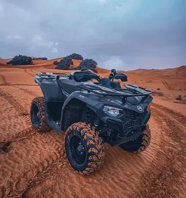 a black atv parked in the desert at Tranquil gem luxury camp in Merzouga