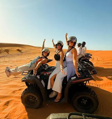 a group of people riding on atvs in the desert at Tranquil gem luxury camp in Merzouga