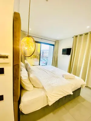 a large bed in a bedroom with a large window at nouvelle studio climatisé in Fès