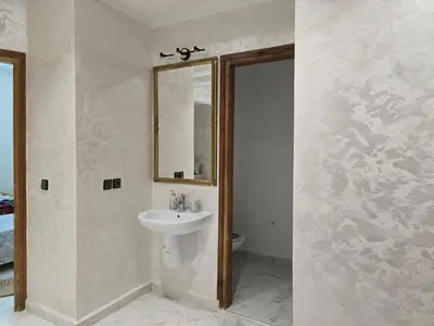 a bathroom with a sink and a mirror at joli appartement à petit prix in Meknès