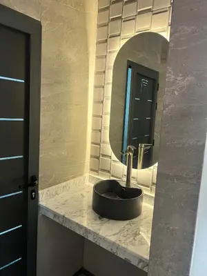 a bathroom with a sink and a mirror at شقق الشرايبي للعائلات فقط in Beni Mellal
