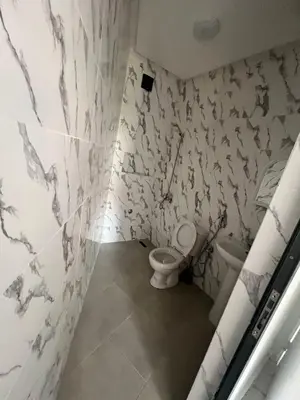 a bathroom with a toilet and a sink at شقق الشرايبي للعائلات فقط in Beni Mellal