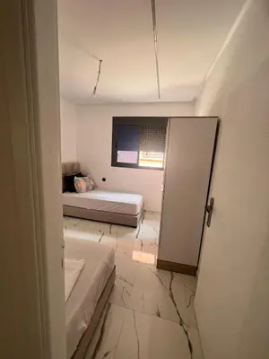 a small room with a bed and a window at شقق الشرايبي للعائلات فقط in Beni Mellal